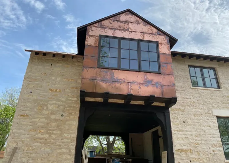 Copper metal panel facade on a stone building for Skylight Installation in Winona Lake