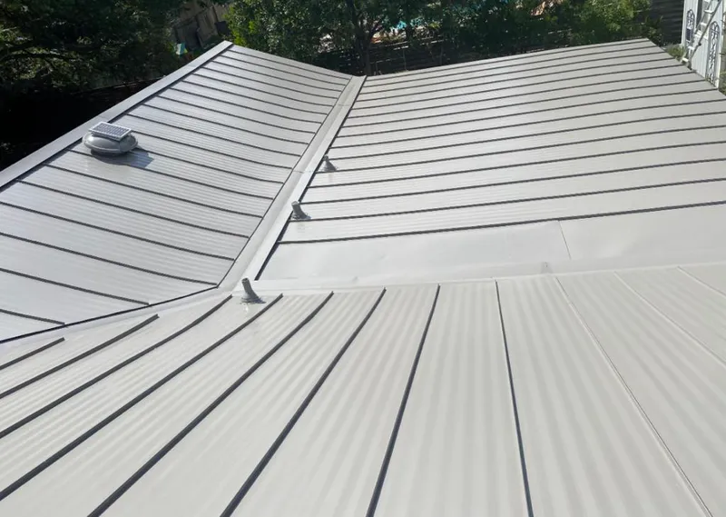 Solar attic fan installed on a metal roof for Roof Ventilation in Winona Lake